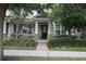 Charming front porch with stone accents and manicured landscaping, offering a welcoming entrance at 8670 Vedder Ln, Orlando, FL 32832