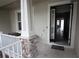 Inviting front porch with an open door providing a glimpse into the well-lit interior spaces at 8670 Vedder Ln, Orlando, FL 32832