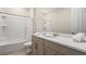 Bathroom view with shower-tub combo, toilet, modern countertops, and a framed mirror at 8928 Coconut Breeze Dr, Kissimmee, FL 34747