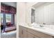 Bathroom featuring double vanity, white counters, and is attached to a themed bedroom at 8928 Coconut Breeze Dr, Kissimmee, FL 34747