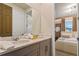 Bathroom view with double sinks, granite countertop and a doorway to a modern bedroom at 8928 Coconut Breeze Dr, Kissimmee, FL 34747