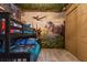 Themed bedroom with bunk beds, dinosaur wallpaper, and unique jungle-themed ceiling decor at 8928 Coconut Breeze Dr, Kissimmee, FL 34747