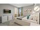 Tastefully decorated bedroom with a king sized bed, modern furniture and neutral decor at 8928 Coconut Breeze Dr, Kissimmee, FL 34747