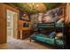 Themed bedroom with bunk beds, dinosaur wallpaper, Jurassic Park Flag and unique jungle-themed ceiling decor at 8928 Coconut Breeze Dr, Kissimmee, FL 34747