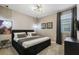 Comfortable bedroom with plush carpets, stylish lighting, and large windows, creating a relaxing atmosphere at 8928 Coconut Breeze Dr, Kissimmee, FL 34747