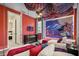 Themed bedroom with two twin beds and lighted mural, orange walls, and a TV in the corner at 8928 Coconut Breeze Dr, Kissimmee, FL 34747