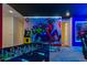 Spacious game room with custom murals, foosball table, and multiple gaming setups at 8928 Coconut Breeze Dr, Kissimmee, FL 34747