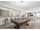 Expansive game room with pool table, bar seating, and access to additional living areas at 8928 Coconut Breeze Dr, Kissimmee, FL 34747