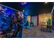 Game room with custom superhero themed wall murals, gaming stations and a foosball table at 8928 Coconut Breeze Dr, Kissimmee, FL 34747
