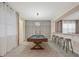 Spacious game room with pool table, bar seating, and contemporary lighting at 8928 Coconut Breeze Dr, Kissimmee, FL 34747