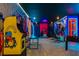 This awesome game room features a foosball table, multiple gaming stations, and superhero-themed decor at 8928 Coconut Breeze Dr, Kissimmee, FL 34747