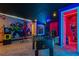 This amazing game room features an arcade machine, foosball table, and Marvel-themed decor at 8928 Coconut Breeze Dr, Kissimmee, FL 34747