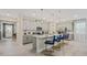 Modern eat-in kitchen featuring stainless appliances, breakfast bar and tiled flooring at 8928 Coconut Breeze Dr, Kissimmee, FL 34747