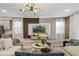 Sleek living room boasting a large sectional, contemporary lighting, and a stylish entertainment center for ultimate comfort at 8928 Coconut Breeze Dr, Kissimmee, FL 34747
