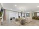 Expansive living room features stylish décor, a large sofa, plush seating, and abundant natural light through sheer curtains at 8928 Coconut Breeze Dr, Kissimmee, FL 34747
