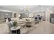 Bright living space boasts an open floor plan, comfortable seating, and a stylish area rug with easy kitchen access at 8928 Coconut Breeze Dr, Kissimmee, FL 34747