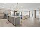 Open-concept living space featuring kitchen island, dining area and comfortable seating at 8928 Coconut Breeze Dr, Kissimmee, FL 34747