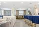 Open-concept living space with bar seating, a dining area and a large white sofa for Gathering relaxation and entertainment at 8928 Coconut Breeze Dr, Kissimmee, FL 34747