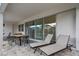 Covered patio with lounge chairs, table set, and sliding glass doors provides an outdoor living space at 8928 Coconut Breeze Dr, Kissimmee, FL 34747