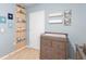 Bedroom features airplane art, library shelf, and changing table at 927 Denali Dr, Orange City, FL 32763