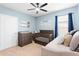 Cozy bedroom features a crib, dresser, and ceiling fan at 927 Denali Dr, Orange City, FL 32763