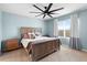 Comfortable bedroom featuring a wooden bed frame, ceiling fan, and natural light at 927 Denali Dr, Orange City, FL 32763