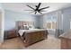 Comfortable bedroom featuring a wooden bed frame, ceiling fan, and natural light at 927 Denali Dr, Orange City, FL 32763