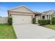 Inviting home showcasing a two-car garage and beautiful landscaping at 927 Denali Dr, Orange City, FL 32763