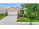 Charming single-story home featuring an attached two-car garage and a well-manicured lawn at 927 Denali Dr, Orange City, FL 32763