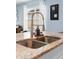 Close-up of a kitchen island featuring a stainless steel sink and granite countertops at 927 Denali Dr, Orange City, FL 32763