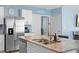 Close-up of kitchen island featuring stainless steel appliances and granite countertops at 927 Denali Dr, Orange City, FL 32763