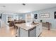 Open concept kitchen with granite island, stainless steel appliances, and adjoining dining area with plenty of seating at 927 Denali Dr, Orange City, FL 32763