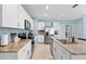 Modern kitchen with stainless steel appliances, granite countertops, and white cabinetry at 927 Denali Dr, Orange City, FL 32763