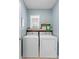 Functional laundry room with washer, dryer, and shelving for storage at 927 Denali Dr, Orange City, FL 32763