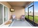 Cozy screened-in patio with comfortable seating and a mounted television at 927 Denali Dr, Orange City, FL 32763