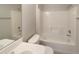 Bathroom featuring tile flooring, white cabinet and shower/bath tub at 9514 Se 168Th Maplesong Ln, The Villages, FL 32162