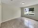 Neutral bedroom featuring tile flooring, light walls and a window at 9514 Se 168Th Maplesong Ln, The Villages, FL 32162