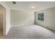 Neutral bedroom featuring gray carpet, light walls and a window at 9514 Se 168Th Maplesong Ln, The Villages, FL 32162