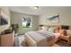 Stylishly decorated bedroom with a comfortable bed, ample natural light, and a cozy rug at 9514 Se 168Th Maplesong Ln, The Villages, FL 32162