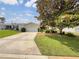 Lovely single-story home with a well-kept lawn and mature landscaping, creating great curb appeal at 9514 Se 168Th Maplesong Ln, The Villages, FL 32162