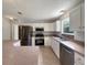 Well-lit kitchen featuring white cabinets, stainless steel appliances, and breakfast bar at 9514 Se 168Th Maplesong Ln, The Villages, FL 32162