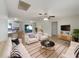 Bright living room featuring tile floors, neutral walls, and sliding door access to outdoor space at 9514 Se 168Th Maplesong Ln, The Villages, FL 32162