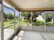 A screened porch with a concrete floor offers lovely backyard views and lots of greenery at 9514 Se 168Th Maplesong Ln, The Villages, FL 32162