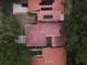 Bird's-eye view of the property highlighting the red tile roofs, solar panels, and mature trees at 1053 W Pebble Beach Cir, Winter Springs, FL 32708