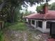 Expansive backyard surrounded by mature trees, offering privacy and a serene outdoor space at 1053 W Pebble Beach Cir, Winter Springs, FL 32708