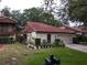 Inviting single-story home with a red tile roof, attached garage, and charming curb appeal at 1053 W Pebble Beach Cir, Winter Springs, FL 32708