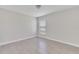 Well-lit bedroom featuring wood look tile flooring and a window letting in natural light at 1206 Beechdale Ct, Deltona, FL 32725