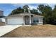 Charming single-story home featuring a well-manicured lawn, attached garage, and inviting front entrance with decorative molding at 1206 Beechdale Ct, Deltona, FL 32725