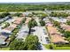 Aerial view of townhomes surrounded by mature trees, lush greenery, and highways in the distance at 1312 Azalea Way, Winter Garden, FL 34787