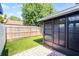A portion of a fenced backyard features artificial grass and a covered patio area at 1312 Azalea Way, Winter Garden, FL 34787